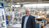 Efficient Factory Management: Portrait of Smiling Senior Manager Businessman or CEO in Industrial Factory Warehouse