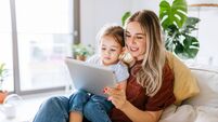 Mother and daughter using a digital tablet together
