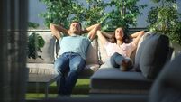 Couple relaxing on a couch in a terrace