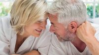 Portrait of a mature couple lying in bed