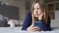 Unhappy Teenage Girl With Mobile Phone Lying On Bed At Home Anxious About Social Media Online Bullying And Using Phone Too Much