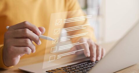 Business performance checklist concept, businessman using laptop doing online checklist survey, filling out digital form checkli