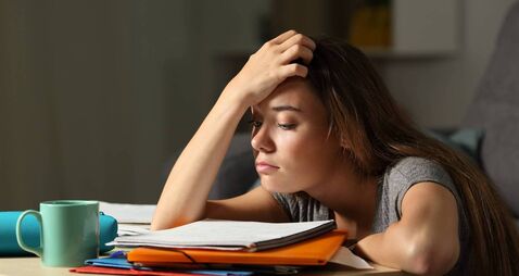 Tired student trying to study in the night