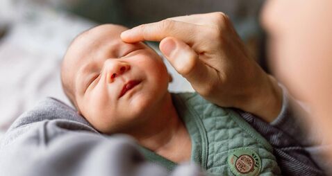 Little baby boy enjoying in mother's touch