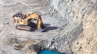 open pit diamond mine, Surface mining hydraulic excavator dinging in the pit, surface water infiltration