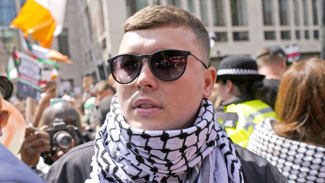 <p>Kneecap's Liam Og O Hannaidh leaves Westminster Magistrates' Court in London, through a crowd of supporters after he appeared charged with a terrorism offence. The 27-year-old from Belfast, who performs under the stage name Mo Chara and is also known as Liam O'Hanna, has been charged with a terrorism offence relating to displaying a flag in support of Hezbollah at a gig at the O2 Forum in Kentish Town on November 21. Picture date: Wednesday June 18, 2025. PA Photo. Photo credit should read: Jordan Pettitt/PA Wire</p>