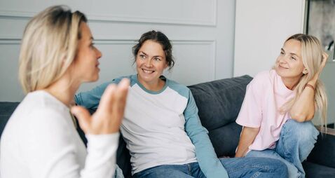 iStock-2193064117.jpg Three Girlfriends Chatting Happily While Sitting On The Couch At Home.