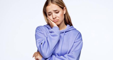 iStock-1399566522.jpg Unhappy teenage girl with head in hand