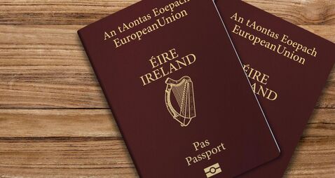 An Irish passport gives citizens of Ireland, a top view of passports on a wooden table