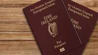 2GJW6EE An Irish passport gives citizens of Ireland, a top view of passports on a wooden table